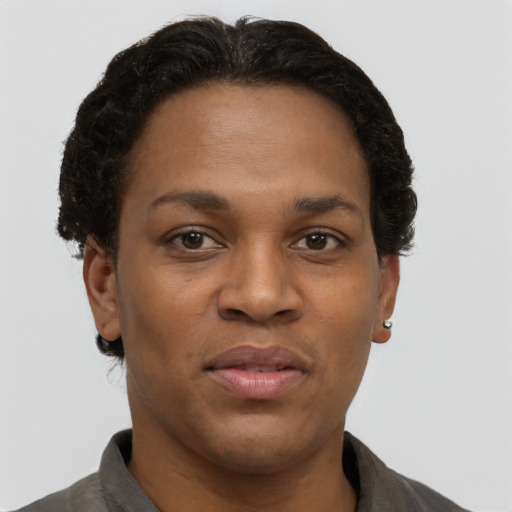 Joyful black adult female with short  brown hair and brown eyes