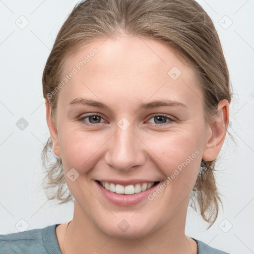 Joyful white young-adult female with medium  brown hair and blue eyes