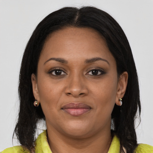 Joyful black young-adult female with medium  brown hair and brown eyes