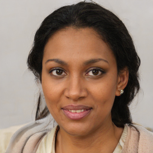 Joyful black young-adult female with medium  brown hair and brown eyes