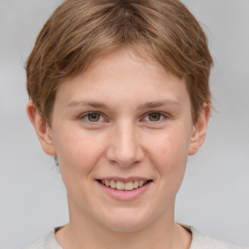 Joyful white young-adult female with short  brown hair and grey eyes