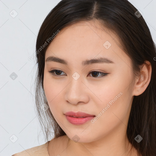 Joyful asian young-adult female with long  brown hair and brown eyes