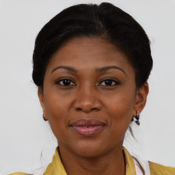 Joyful black adult female with short  brown hair and brown eyes