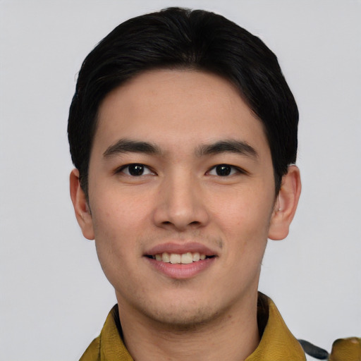 Joyful asian young-adult male with short  black hair and brown eyes