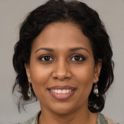 Joyful black young-adult female with medium  brown hair and brown eyes
