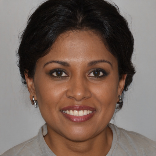 Joyful black young-adult female with medium  brown hair and brown eyes
