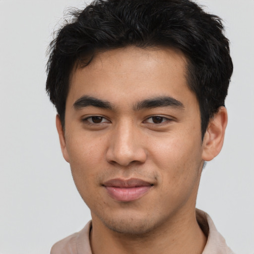 Joyful asian young-adult male with short  brown hair and brown eyes