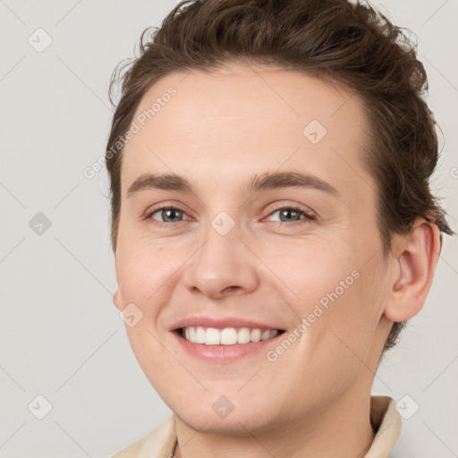 Joyful white young-adult female with short  brown hair and grey eyes