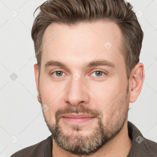 Joyful white adult male with short  brown hair and brown eyes