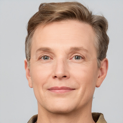 Joyful white adult male with short  brown hair and grey eyes