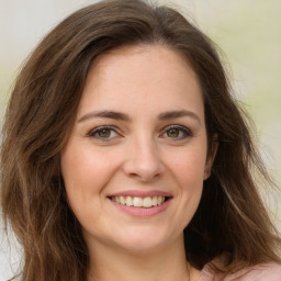 Joyful white young-adult female with long  brown hair and green eyes