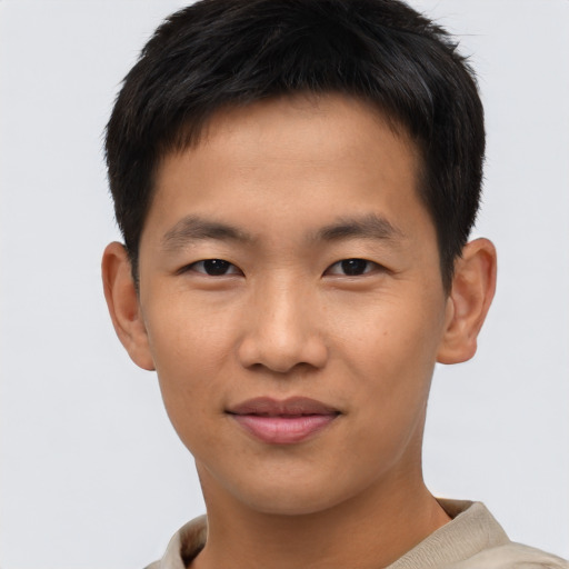 Joyful asian young-adult male with short  brown hair and brown eyes