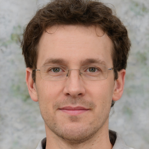 Joyful white adult male with short  brown hair and grey eyes