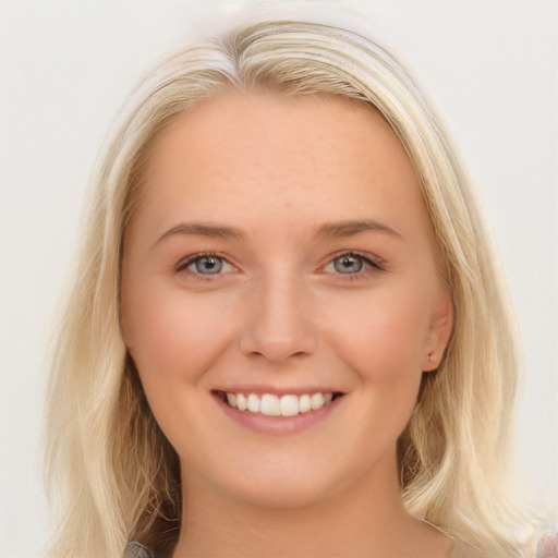 Joyful white young-adult female with long  brown hair and blue eyes