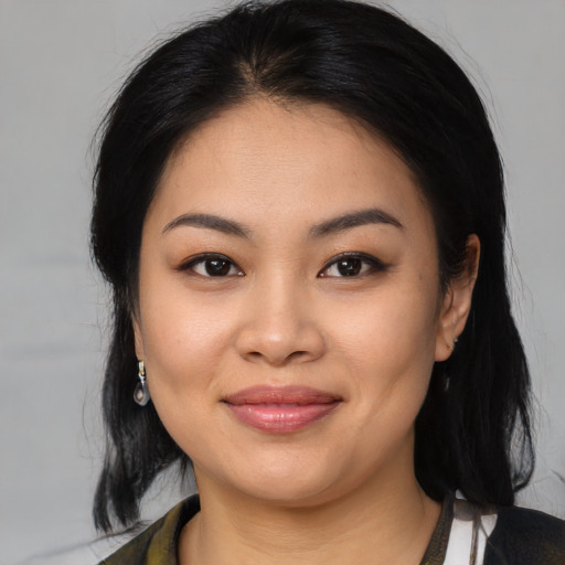 Joyful asian young-adult female with medium  black hair and brown eyes