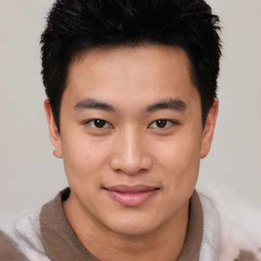 Joyful asian young-adult male with short  brown hair and brown eyes