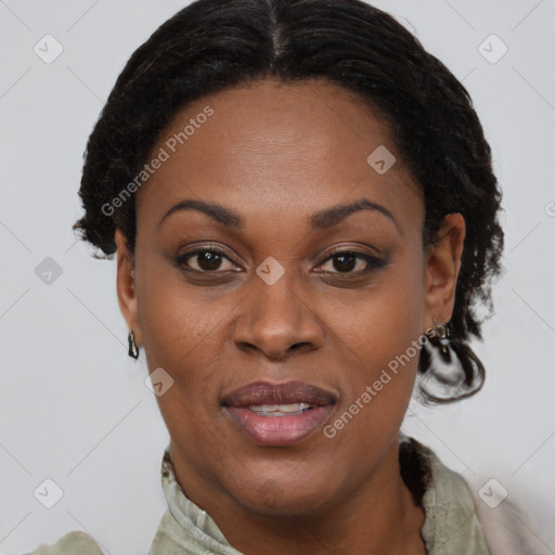 Joyful black adult female with short  brown hair and brown eyes