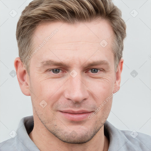 Joyful white adult male with short  brown hair and grey eyes