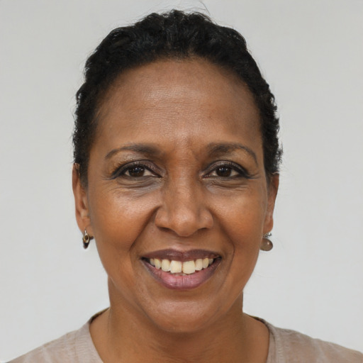 Joyful black adult female with short  brown hair and brown eyes