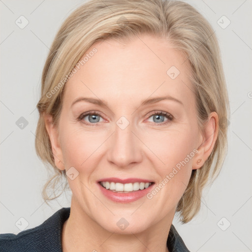 Joyful white adult female with medium  brown hair and blue eyes