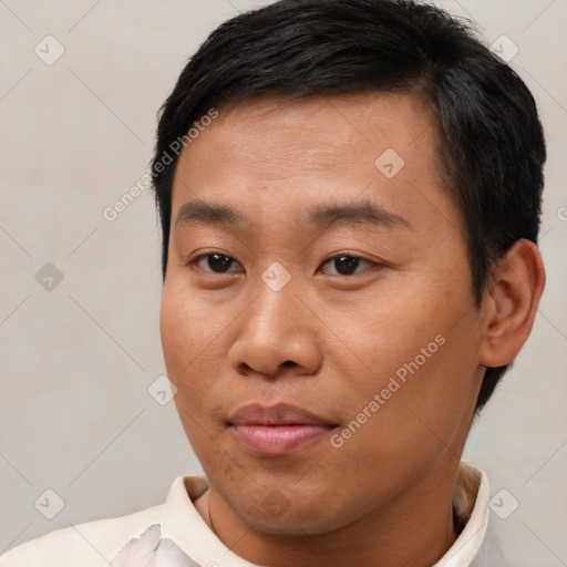 Joyful asian young-adult male with short  brown hair and brown eyes