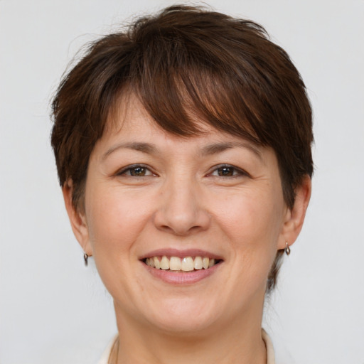 Joyful white adult female with medium  brown hair and brown eyes