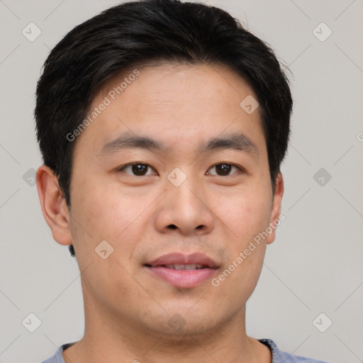 Joyful asian young-adult male with short  black hair and brown eyes