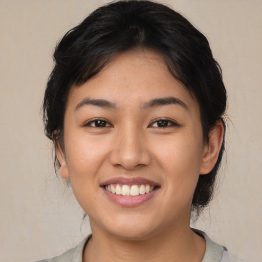 Joyful asian young-adult female with medium  brown hair and brown eyes