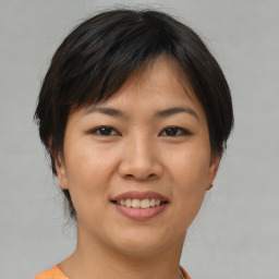 Joyful asian young-adult female with short  brown hair and brown eyes