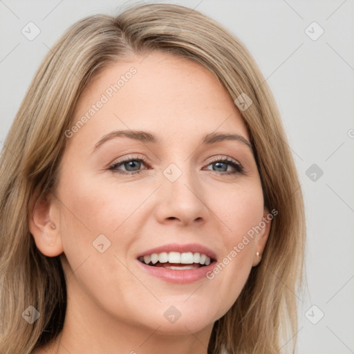 Joyful white young-adult female with long  brown hair and blue eyes