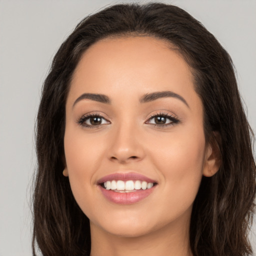 Joyful white young-adult female with long  brown hair and brown eyes