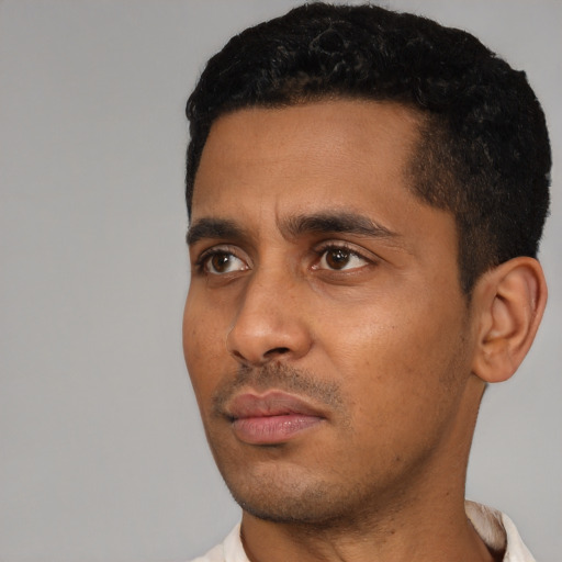 Neutral latino young-adult male with short  black hair and brown eyes