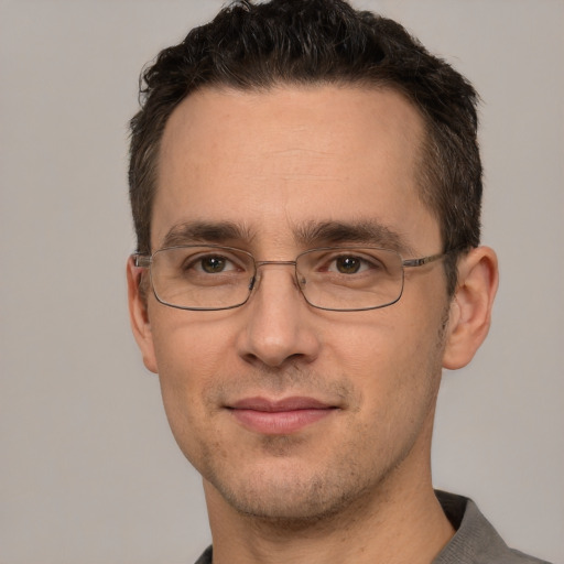 Joyful white adult male with short  brown hair and brown eyes