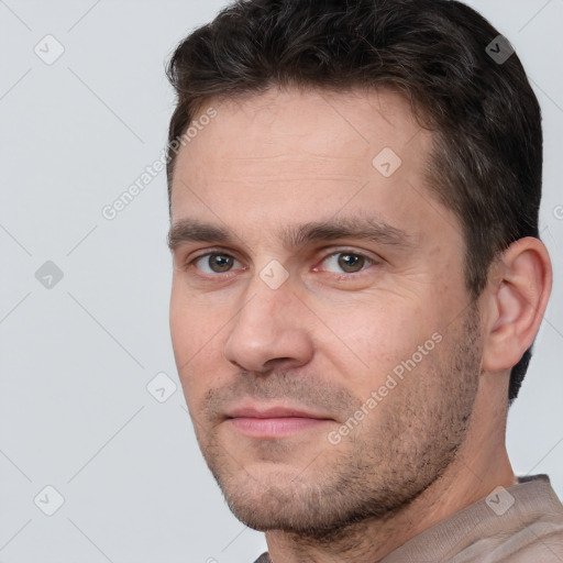 Joyful white adult male with short  brown hair and brown eyes