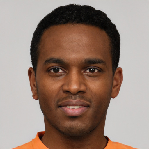 Joyful black young-adult male with short  black hair and brown eyes
