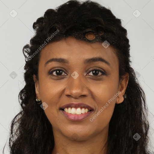 Joyful black young-adult female with long  brown hair and brown eyes