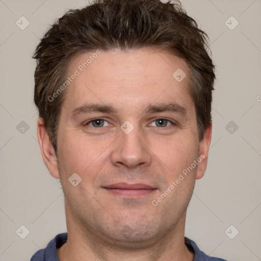 Joyful white adult male with short  brown hair and grey eyes