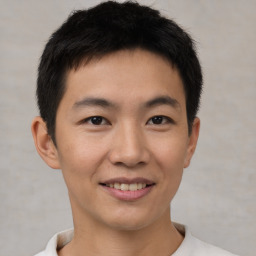 Joyful asian young-adult male with short  brown hair and brown eyes