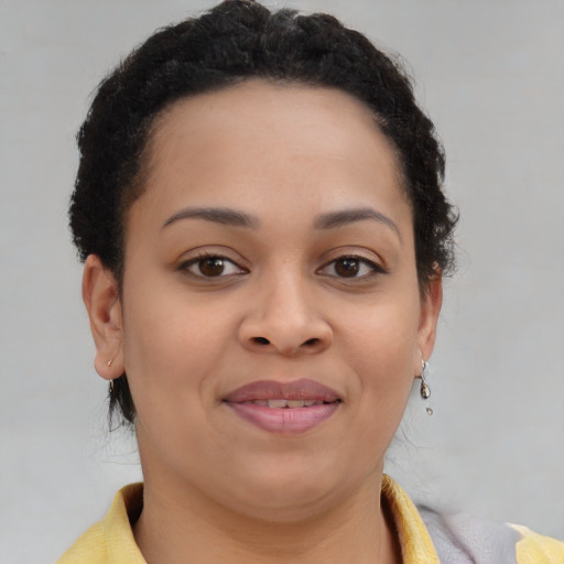 Joyful latino young-adult female with short  brown hair and brown eyes
