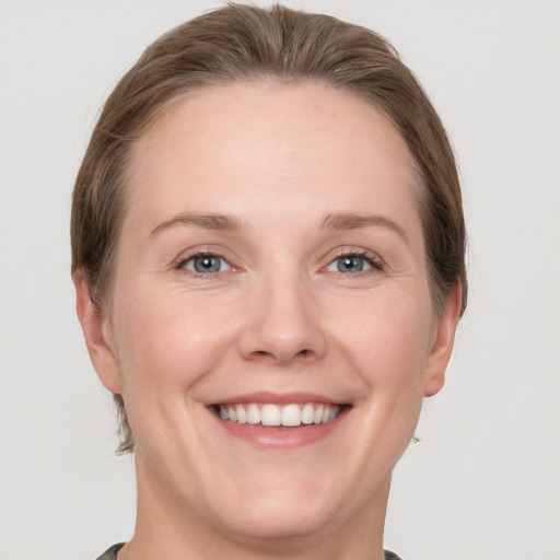 Joyful white adult female with short  brown hair and grey eyes