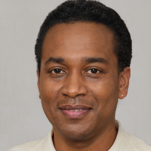 Joyful black young-adult male with short  black hair and brown eyes