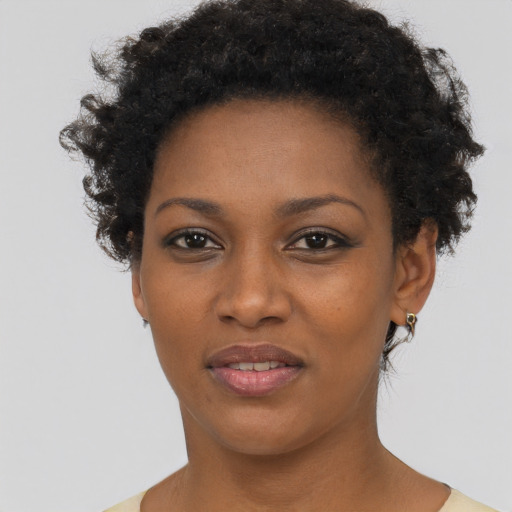 Joyful black young-adult female with short  brown hair and brown eyes