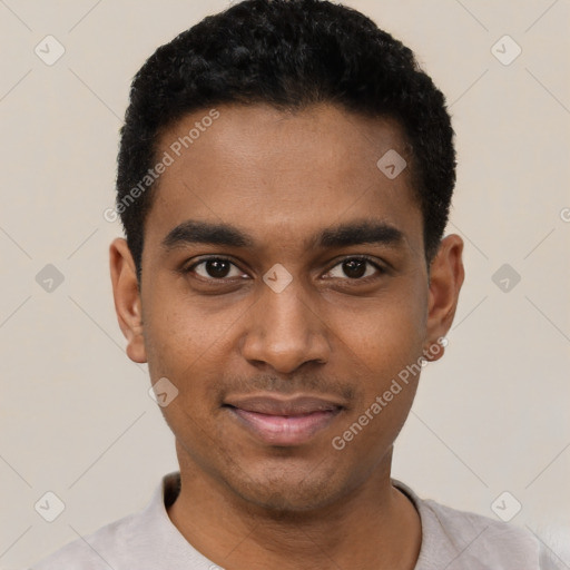 Joyful black young-adult male with short  black hair and brown eyes