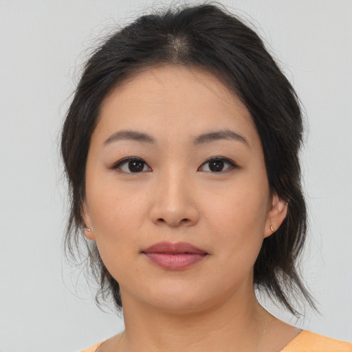Joyful asian young-adult female with medium  brown hair and brown eyes