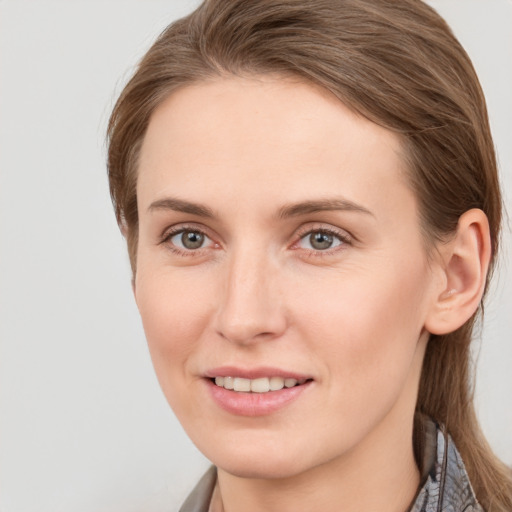 Joyful white young-adult female with medium  brown hair and grey eyes