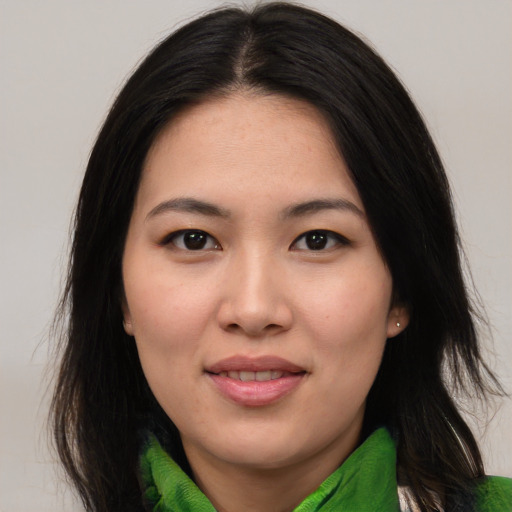 Joyful asian young-adult female with medium  brown hair and brown eyes