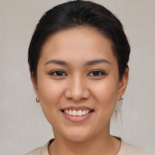 Joyful asian young-adult female with short  brown hair and brown eyes