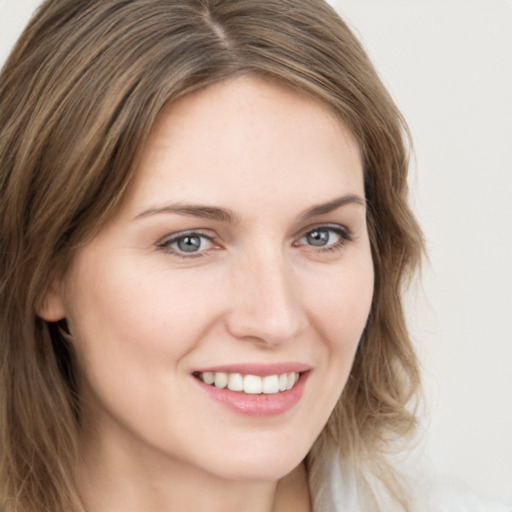 Joyful white young-adult female with long  brown hair and grey eyes