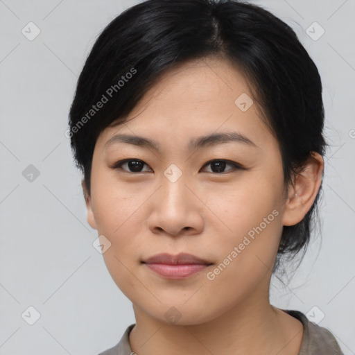 Joyful asian young-adult female with medium  black hair and brown eyes