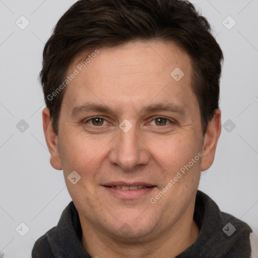 Joyful white adult male with short  brown hair and grey eyes